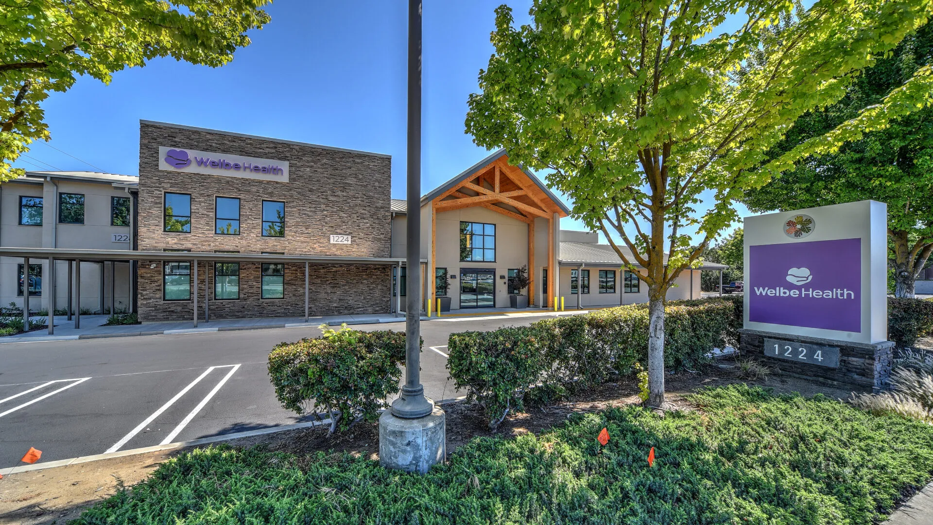 Mazda dealership showroom with various cars on display.