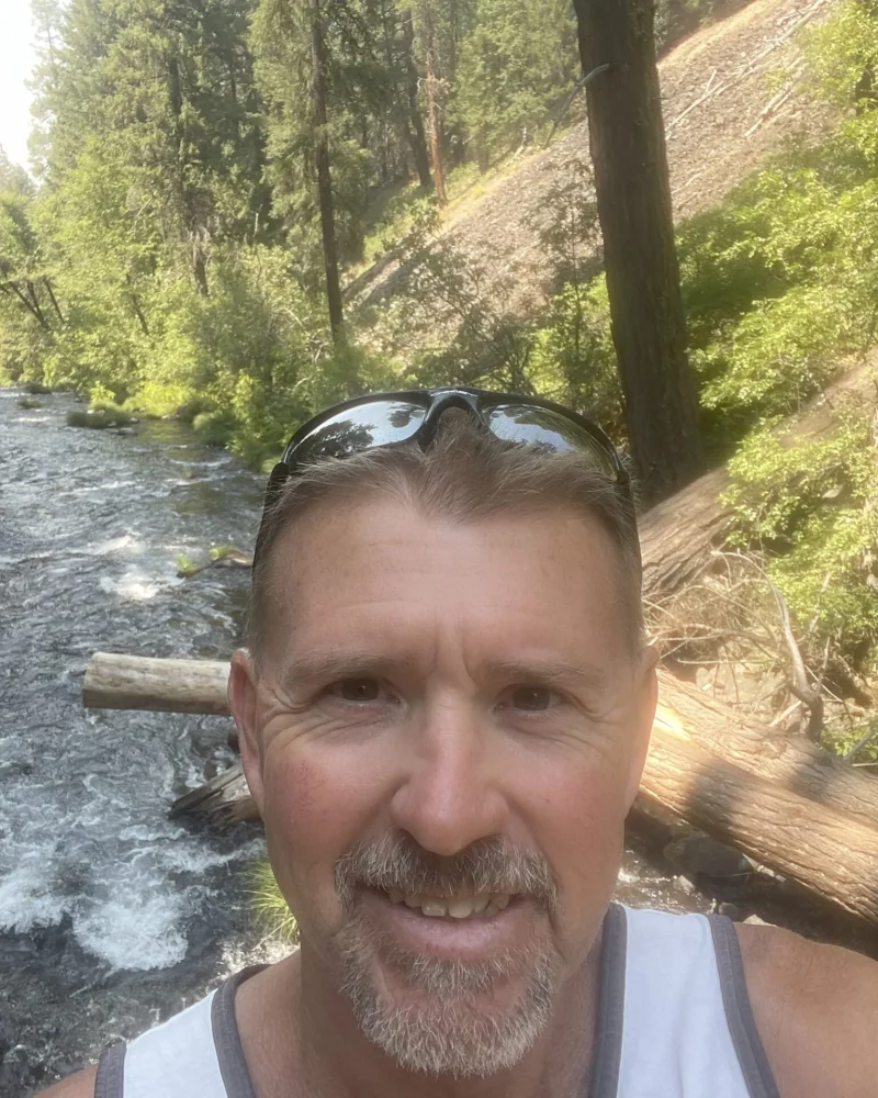 Paul standing by a river
