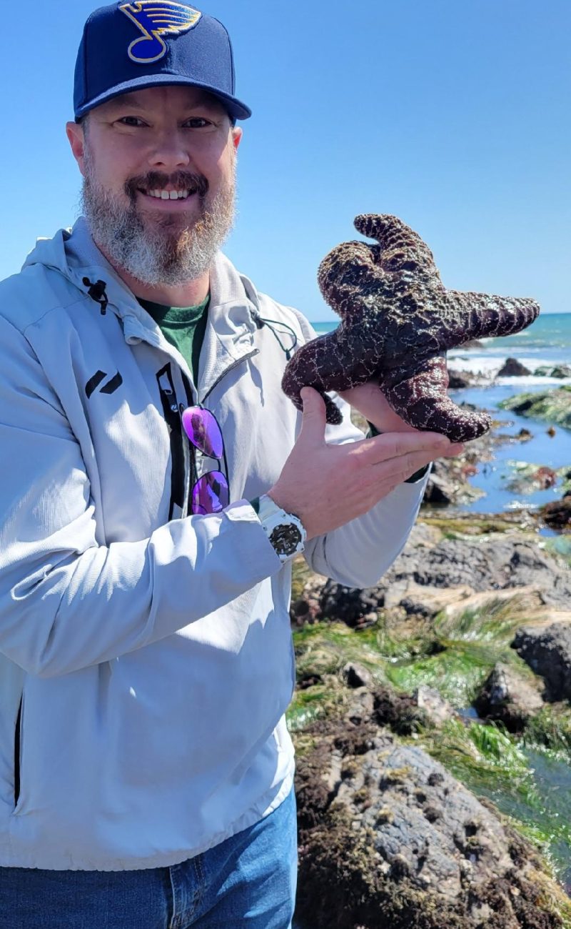 Evan Smith holding a starfish